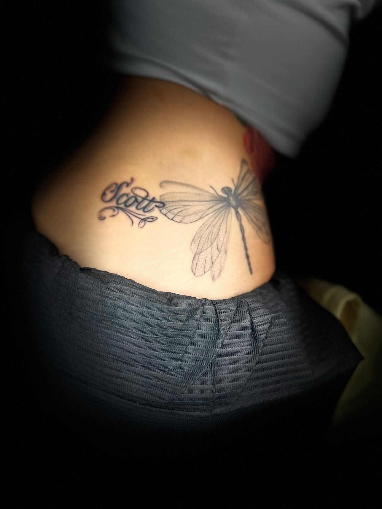 Dragonfly and script tattoo